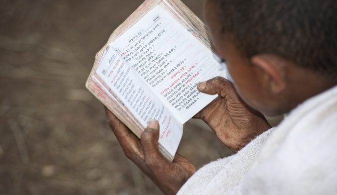 Novice in an orthodox monastery is reading a holy book