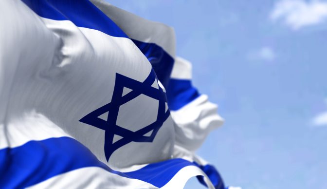 Detail of the national flag of Israel waving in the wind on a clear day