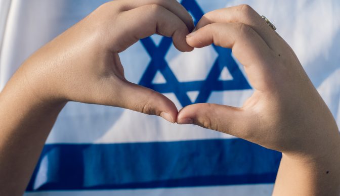 Child’s Heart-Shaped Hands Frame Magen David on Israeli Flag.